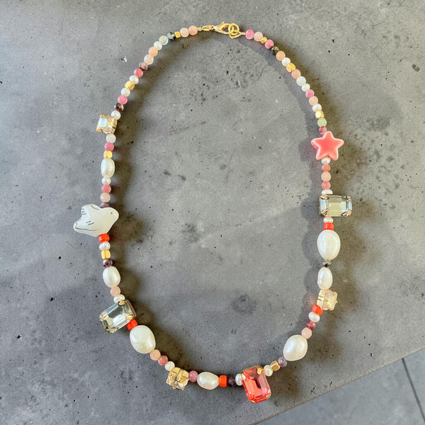 This unique design features a beautiful mix of natural pearls, colourful gemstones, sparkling crystal accents, and delicate beads, carefully arranged to create a soft yet eye-catching piece.